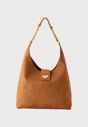 Pruun seemisnahast käekott krokodillinahkse mustriga, kuldse tooni kett- rihm ja ristkülikukujuline kuldne kinnitus.