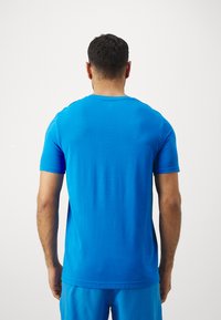 Under Armour VANISH SEAMLESS NOVELTY  - Print T-shirt - blue atlantis/white