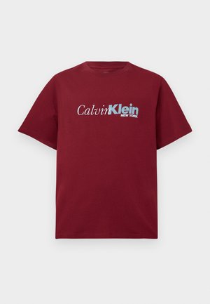 Burgundy short-sleeve T-shirt with "Calvin Klein New York" logo in white and light blue across the chest.