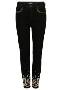 Jeans ajustados negros con bordado en bucle marrón cerca de los bolsillos delanteros y bordados en color beige de motivos paisley y florales en las piernas inferiores con dobladillos deshilachados.