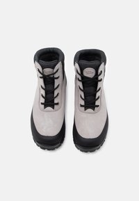 Botas de caminhada cinzas e pretas com parte superior em camurça, atacadores pretos, colarinho almofadado e sola de borracha texturizada para tração.