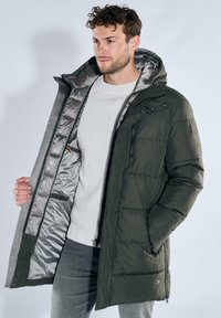Green puffer coat with a hood, featuring a gray interior, front zipper, and pockets, made from quilted fabric for warmth.