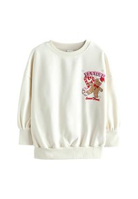 White sweatshirt with a round neckline and balloon sleeves. Features a festive gingerbread man and candy cane graphic in pink and brown.