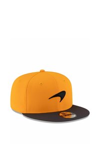 Gelbe Kappe mit einem schwarzen Schirm und einem auffälligen schwarzen Nike-Logo auf der Vorderseite. Hergestellt aus glattem Stoff mit Belüftungslöchern oben.