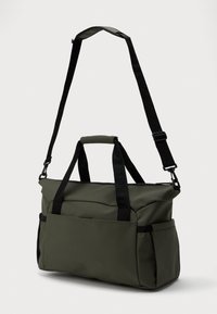 Τσάντα από υλικό ελαιόχρουν, αδιάβροχη, με ρυθμιζόμενους μαύρους ιμάντες, διπλούς επάνω χερουργούς και λεπτομέρειες εξωτερικής τσέπης.