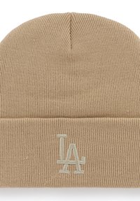 Beige knit beanie with a fold-over cuff. Features a subtle embroidered "LA" logo in light gray. Made from soft, stretchy fabric.