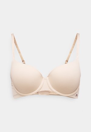 Soutien-gorge rembourré beige avec armature, bretelles réglables de marque "Tommy Hilfiger", et petit logo drapeau Tommy Hilfiger sur le bord de la bande.