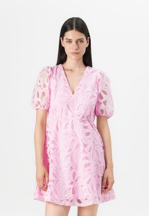 Lace dress in light pink with puff sleeves, V-neckline, and floral pattern. Elastic waist and A-line silhouette with sheer texture.
