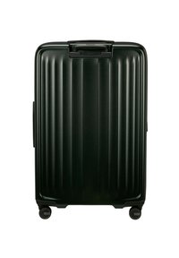 Hard-shell suitcase in dark green, featuring vertical ridges, a top handle, and four smooth-rolling wheels for mobility.