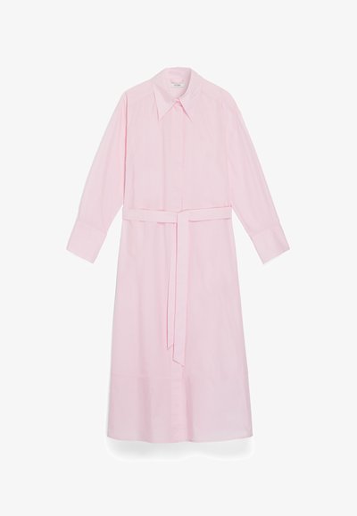 Light pink long-sleeve dress made of smooth fabric. Features a pointed collar, a front button closure, and a tied waist belt.