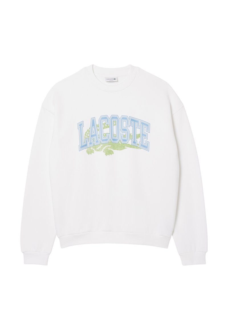 Sweatshirt bianco realizzato in morbido tessuto con logo "LACOSTE" blu e grafica di un coccodrillo verde. Vestibilità ampia con polsini e orlo a costine.