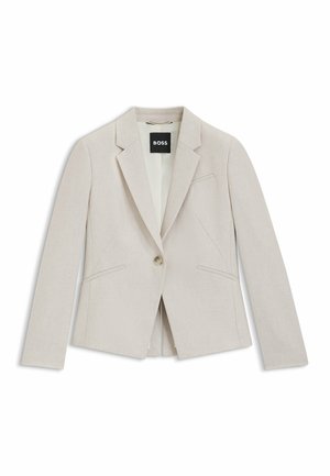Blazer beige chiaro realizzato in tessuto testurizzato. Presenta una chiusura con un solo bottone, revers a punta e due tasche frontali.