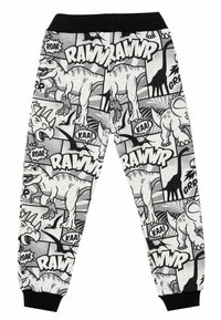 Schwarz-weiße Jogginghosen mit Dinosaurierdruck, die verschiedene Dinosaurierillustrationen und Comic-artige Texthighlights zeigen; elastischer Bund und Bündchen.
