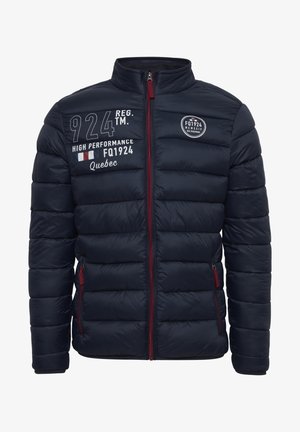 Sooja tumesinine jakk kõrge kraega, ees lukuga ja punaste detailidega. Rinnal ja vasakul varrukal on valged tekstid ja logod.