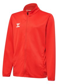 Giacca rossa con cerniera, realizzata in materiale liscio e leggero. Presenta un colletto alto, tasche laterali e il logo "hummel" sul petto.