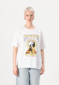 White cotton T-shirt with short sleeves featuring a colorful graphic of a sun and moon, text "Enjoy Every Day" in a playful font.