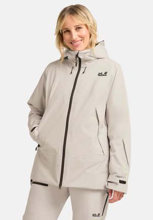 Giacca impermeabile beige chiaro con cappuccio, dotata di zip frontale, tasche laterali e dettagli con logo. Realizzata in resistente materiale TEXAPORE.