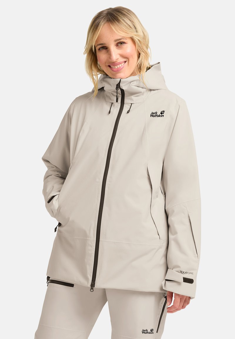 Veste imperméable beige clair avec capuche, dotée d'une fermeture éclair à l'avant, de poches latérales et d'accents de logo. Fabriquée en matériau TEXAPORE durable.