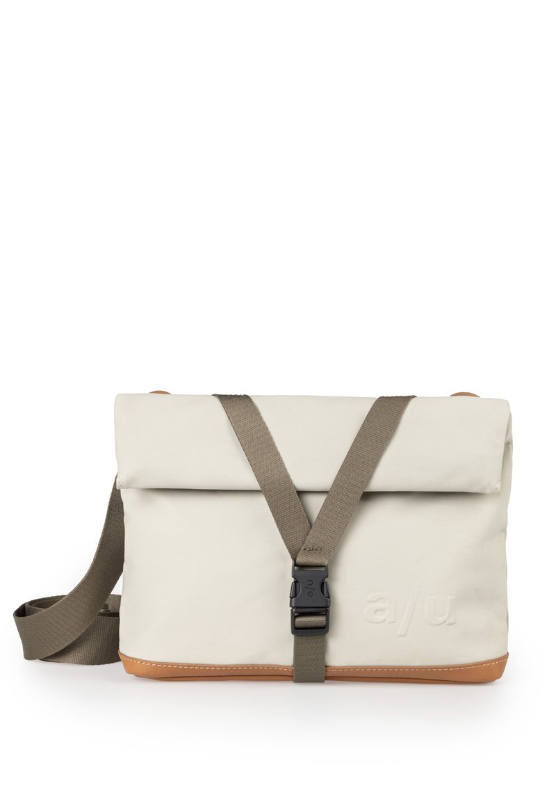 Schultertasche aus cremefarbenem Stoff mit einem braunen Lederboden. Sie verfügt über einen umklappbaren Deckel, einen verstellbaren Riemen und einen Kunststoffschnallenverschluss.