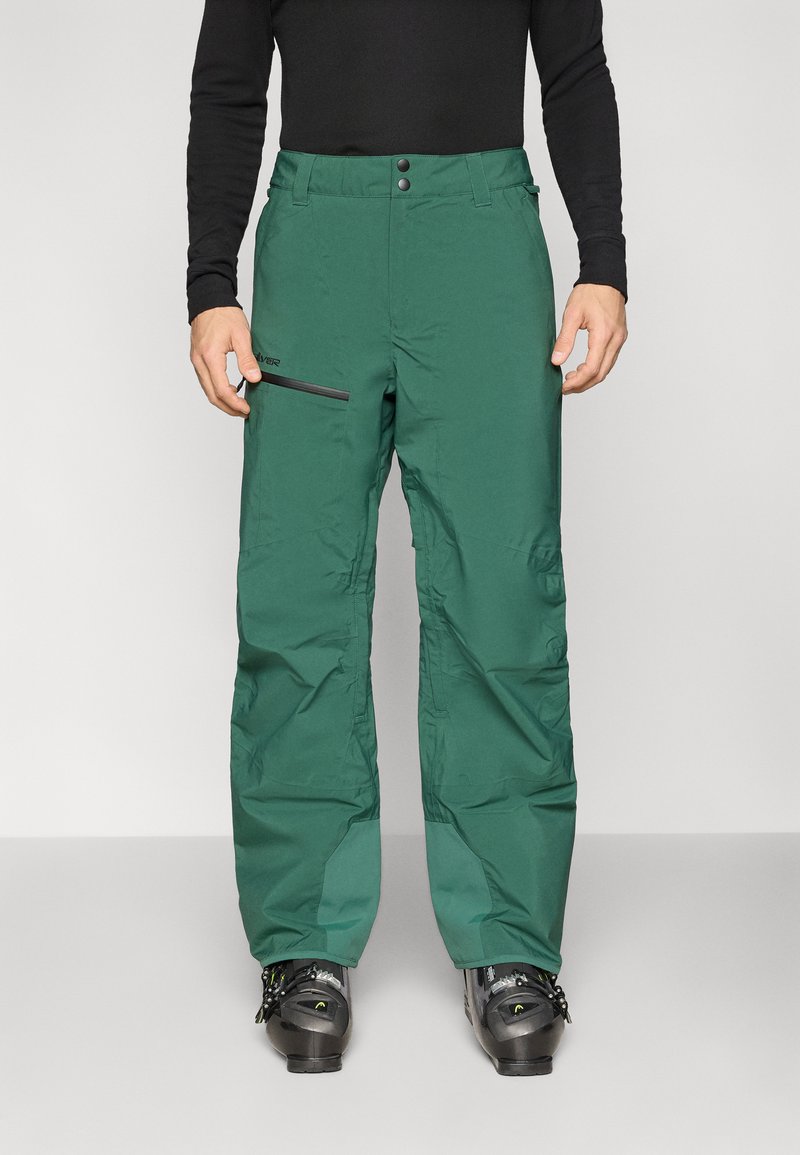 Žalios žieminės kelnės laisvo kirpimo, pagamintos iš vandeniui atsparios medžiagos. Ypatybės: du priekiniai mygtukai, šoninėje pusėje esanti kišenė su užtrauktuku ir patvarios siūlės.