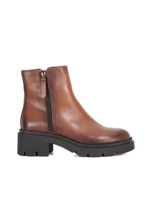 Brown leather ankle boot with a side zipper, chunky black heel, smooth texture, and rounded toe. Features minimal stitching and a sleek profile.