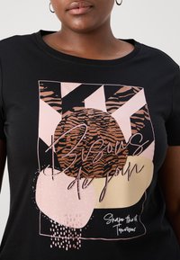 Black short-sleeve T-shirt featuring a graphic design with abstract shapes in pink, brown, and beige, with stylized text and a textured look.
