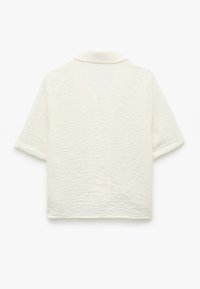 Kortärmad, krämfärgad skjorta med en texturerad yta och krage. Rutig design med en lös passform och rak nederkant.