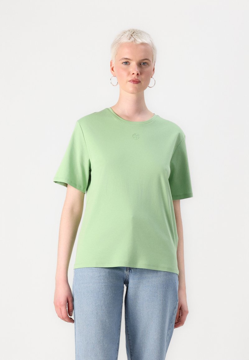 Šviesiai žalia trumpa rankovė t-shirta, pagaminta iš minkštos medvilnės, su apvaliu kaklu ir subtiliu logotipu, siuvinėtu ant krūtinės.