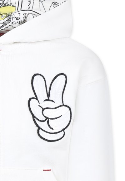 Hoodie blanc avec un grand signe de paix noir brodé sur le devant. L'intérieur de la capuche présente un motif de bande dessinée coloré.