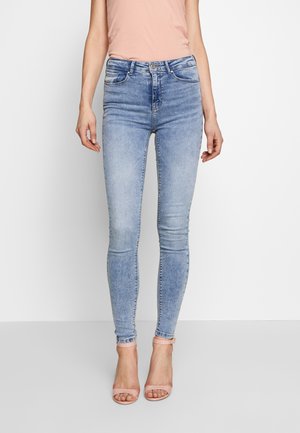 Light blue skinny jeans made of denim, featuring a high waist, five-pocket design, and subtle fading on the front.
