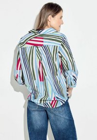 Multicolored striped shirt in blue, green, red, and white. Features a relaxed fit, fold-down collar, and mid-length sleeves.