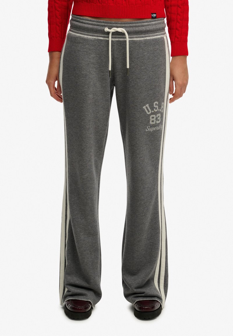 Grå sweatpants med hvide sidelister, har en snor i taljen og U.S.A. 83-logo. Fremstillet af blødt stof, der giver en afslappet pasform.