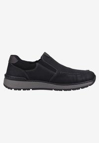 Zapatos negros tipo slip-on de cuero con detalles en gris, que cuentan con una suela de goma texturizada, costuras decorativas y paneles laterales elásticos.