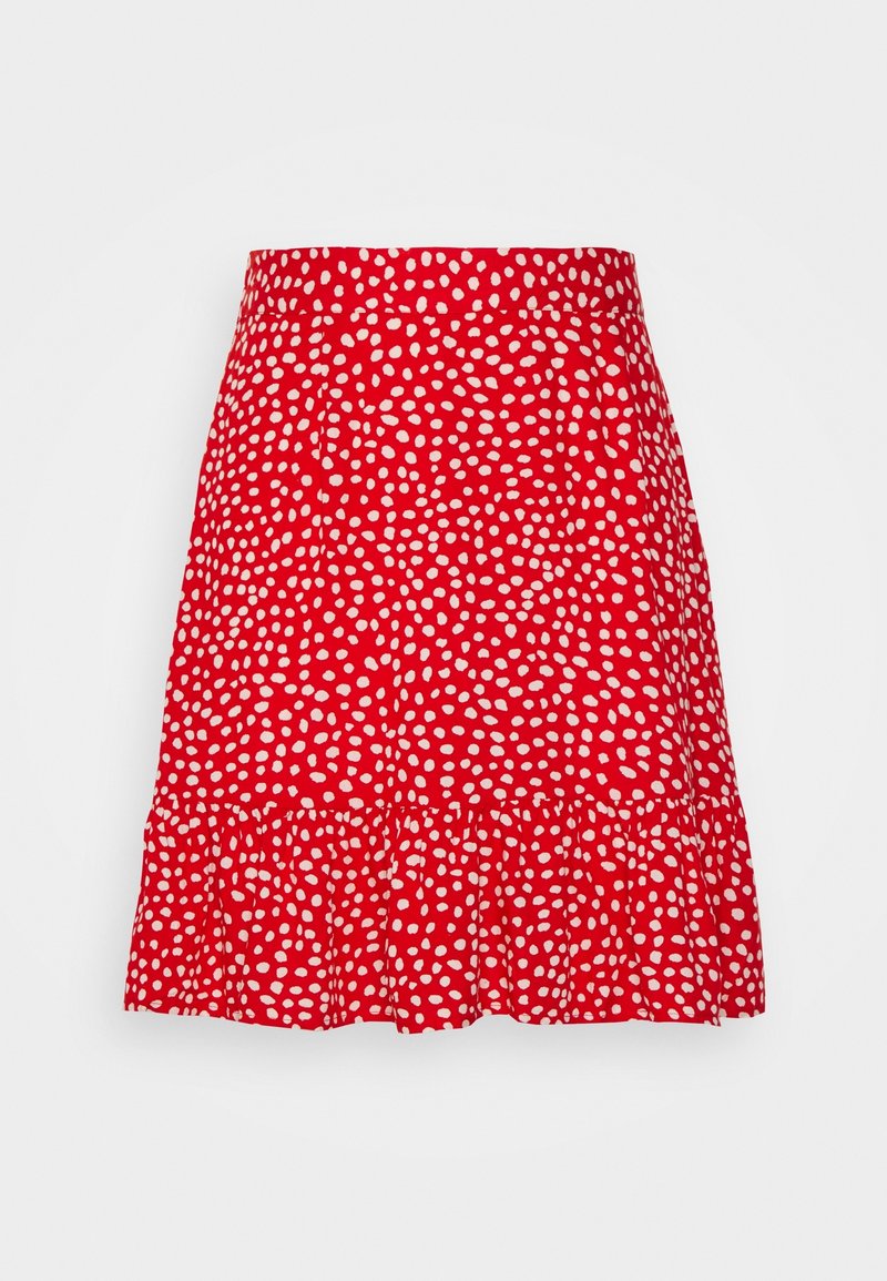 Jupe rouge à pois blancs, avec un ourlet à volants et une taille ajustée. Fabriquée en tissu léger à texture lisse.