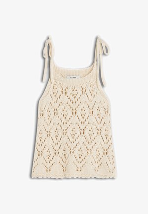 Top de tirantes tejido color crema con dobladillo en forma de ondas y lazos en los hombros, con un patrón de encaje de diamantes y flores.