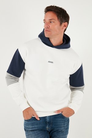 Hooded sweatshirt in white, navy, and gray. Features color-blocked sleeves and a front text design. Soft fabric with ribbed cuffs.