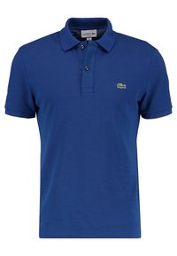 Blue polo shirt made of cotton, featuring a textured fabric, a two-button placket, short sleeves, and an embroidered green crocodile logo.