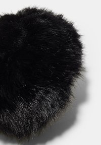Black faux fur heart-shaped accessory with a fluffy texture, featuring glossy strands and a soft, rounded edge.