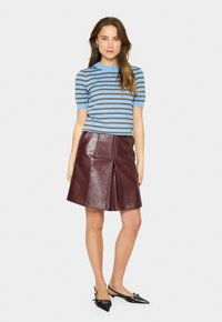 Blue and brown striped short-sleeve top paired with a burgundy leather A-line skirt, featuring a front pleat and smooth texture.