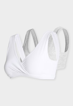 Deux soutiens-gorge à bonnets souples, un blanc et un gris clair, avec des bretelles larges et un design simple et sans coutures sur un fond uni.