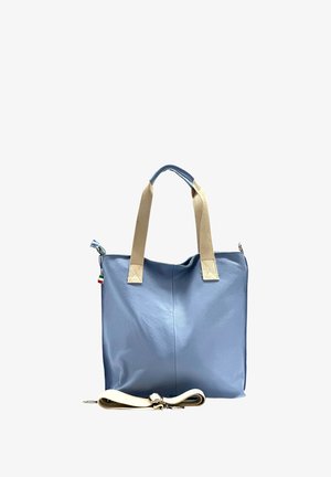 Light blue leather tote bag with beige canvas straps and a removable shoulder strap. Features a subtle texture and a small Italian flag accent.