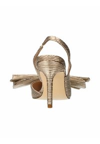 Sandales à talons hauts métalliques dorées avec une texture plissée, un dos ouvert et une bride de cheville. Présente un talon effilé et un détail en nœud décoratif.