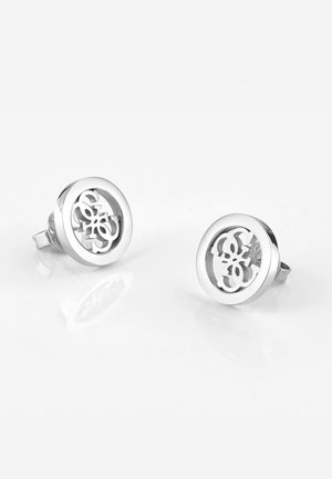 Orecchini a bottone in argento con un design circolare che presenta un motivo a ritaglio. Superficie liscia e riflettente con una finitura lucida.