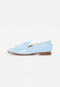 Light blue patent leather loafers with a decorative fringe detail, almond-shaped toe, and low brown heel. Smooth texture throughout.