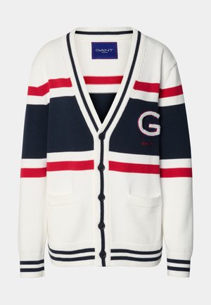 White cardigan with navy, red, and white stripes, featuring a deep V-neck, five black buttons, and two front pockets. Embroidered logo detail.