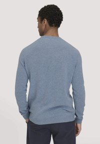 Blauwe gebreide trui met lange mouwen, ronde hals en geribbelde zoom. Zachte textuur, egale kleur en een simpel ontwerp zonder patronen of accenten.