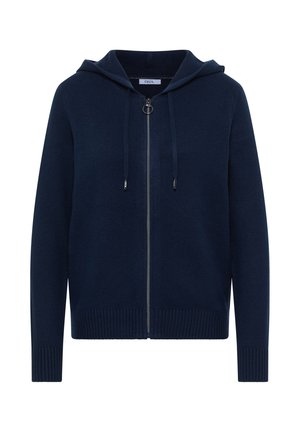 Tummansininen huppari, jossa on vetoketju edessä, resorit helmassa ja hihansuissa sekä kaksi kiristysnauhaa. Valmistettu pehmeästä neuloksesta ja minimalisella designilla.