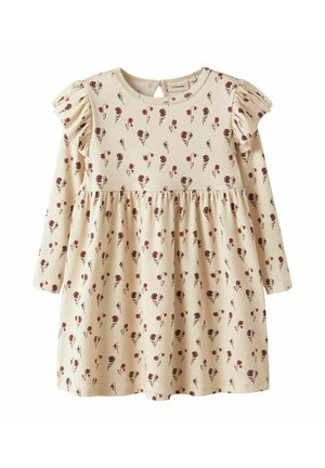 Robe beige clair à manches longues, motif floral rouge et vert, texture côtes, jupe froncée et accents à volants sur les épaules.