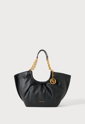 Black leather Michael Kors handbag with gathered top, gold chain handles, and round gold logo charm on one side.