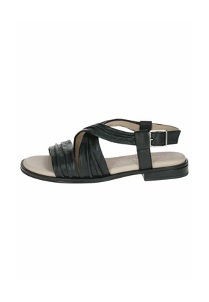 Sandale en cuir noir avec semelle plate, présentant un design à brides croisées, fermeture à boucle, et une texture légèrement brillante sur la partie supérieure.